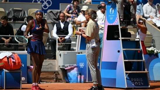 La estadounidense Coco Gauff habla con un árbitro después de que se tomara una decisión en su contra mientras jugaba contra la croata Donna Vekic durante su partido de tenis de tercera ronda individual femenino. (AFP)