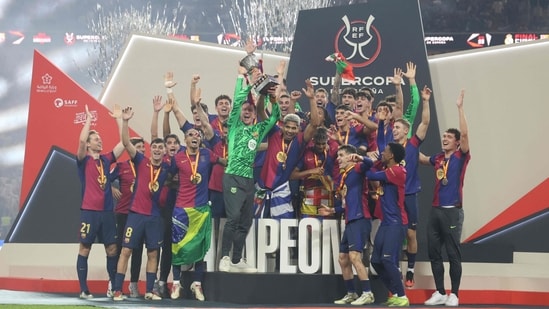 Los jugadores del Barcelona celebran con el trofeo tras ganar la Supercopa de España(AFP)